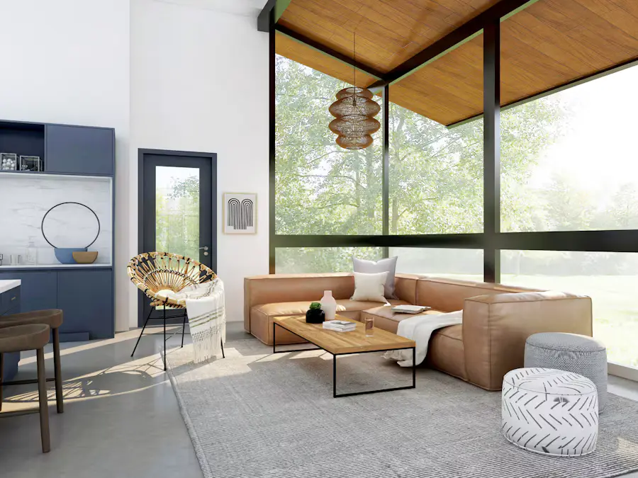 A sunlit lounge with a leather sofa and floor-to-ceiling windows